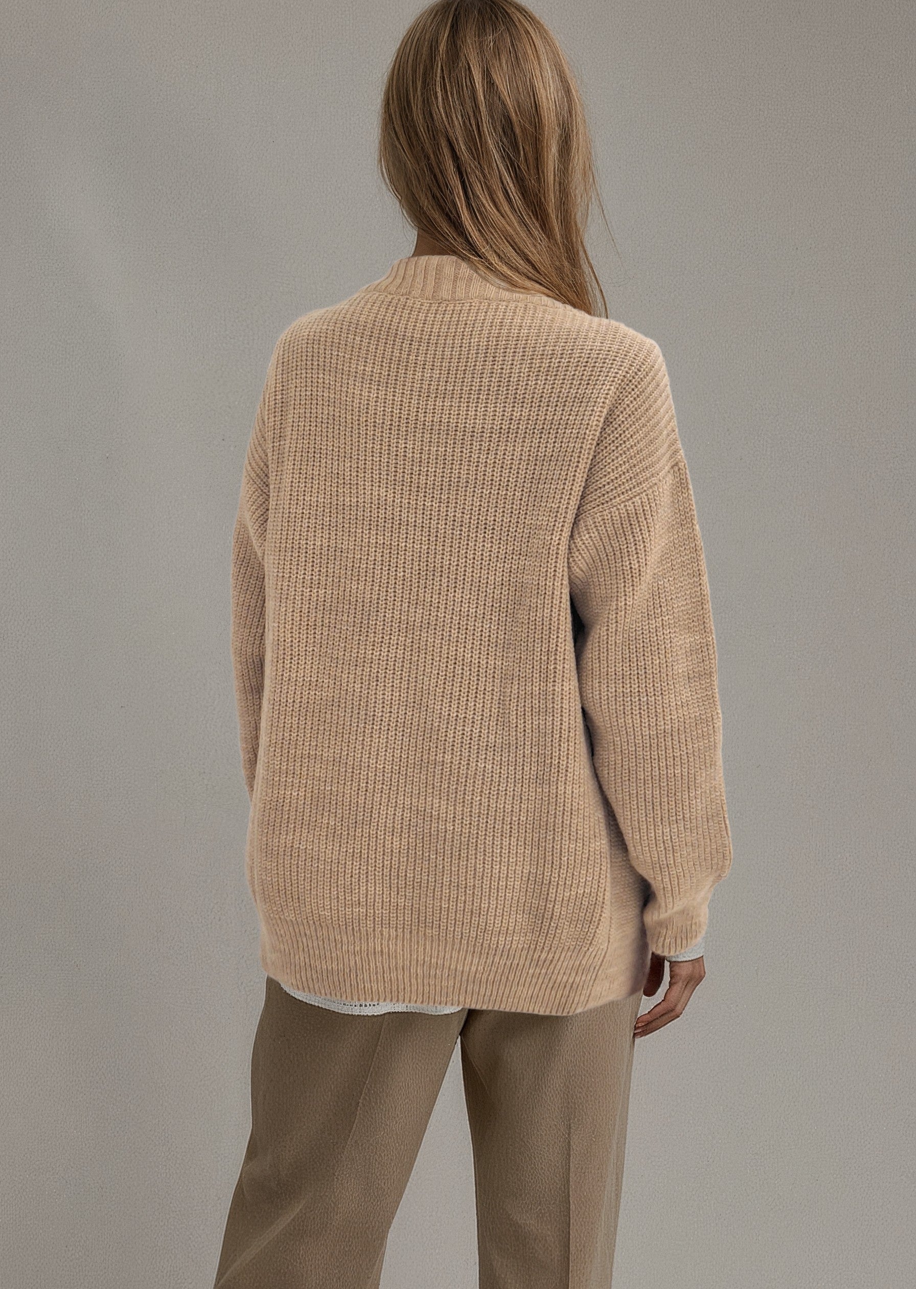 Back view of the Brio Beige knit sweater worn by a model.